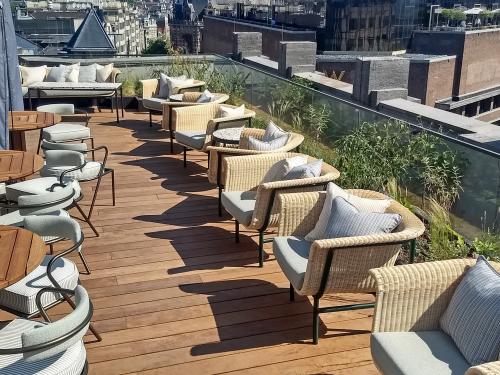 Roof terrace with wooden decking and chairs